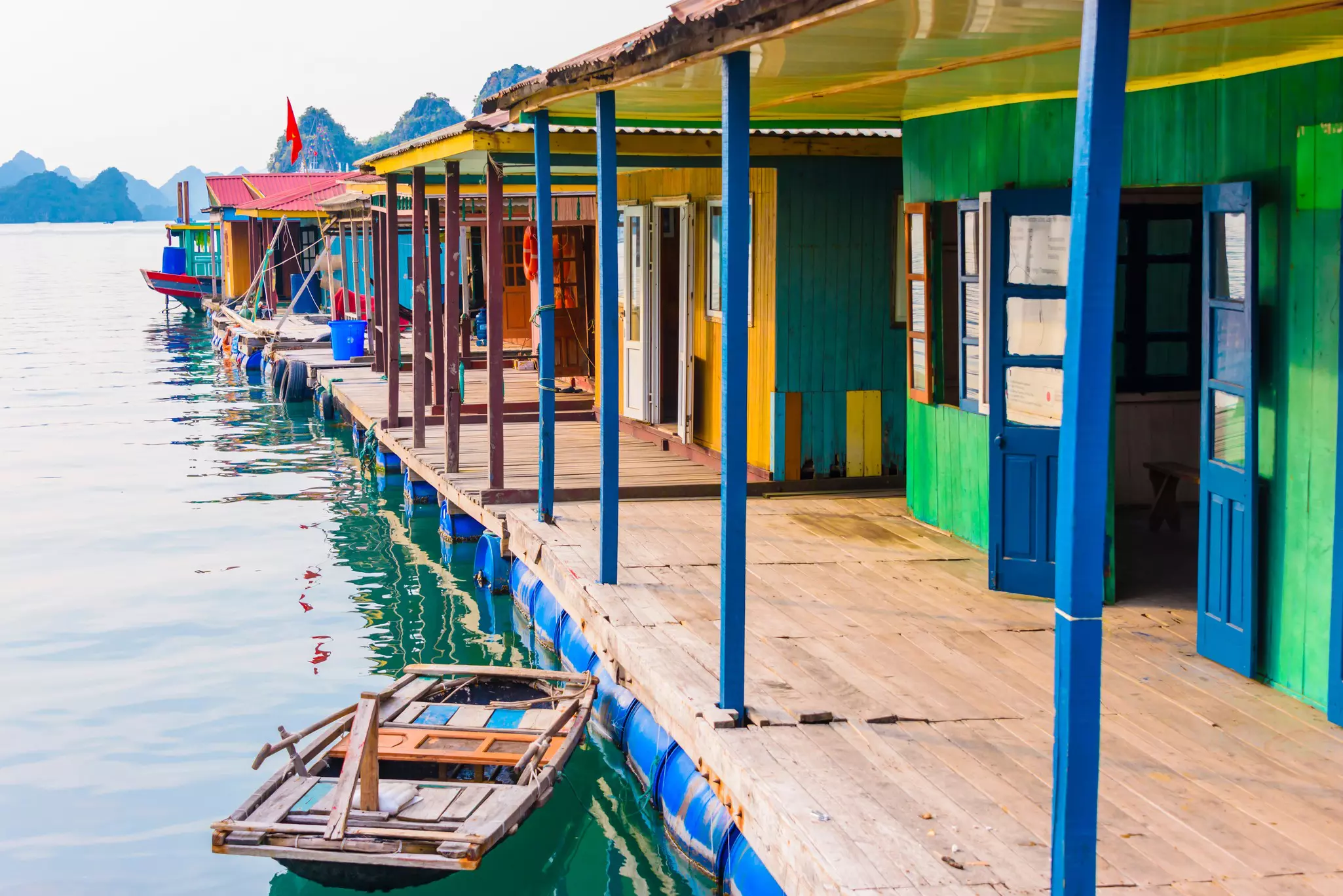 Multicolored houses are built over a platform in a bay in Vietnam.