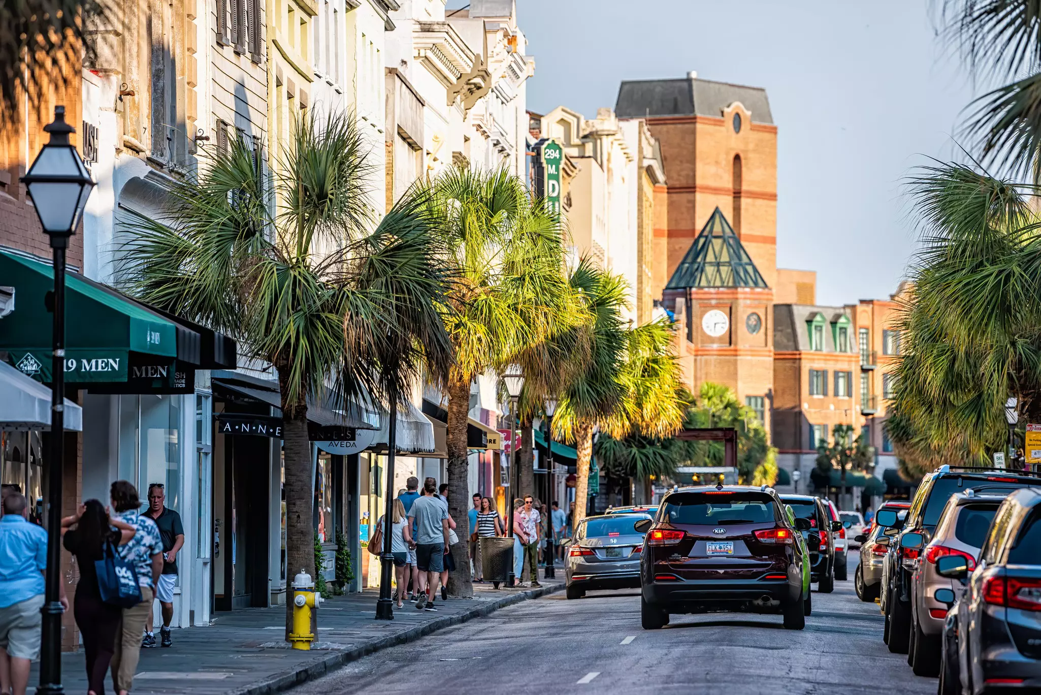 Downtown district in city with King street in South Carolina with cars and people in southern town shopping and view of Belmond Place hotel