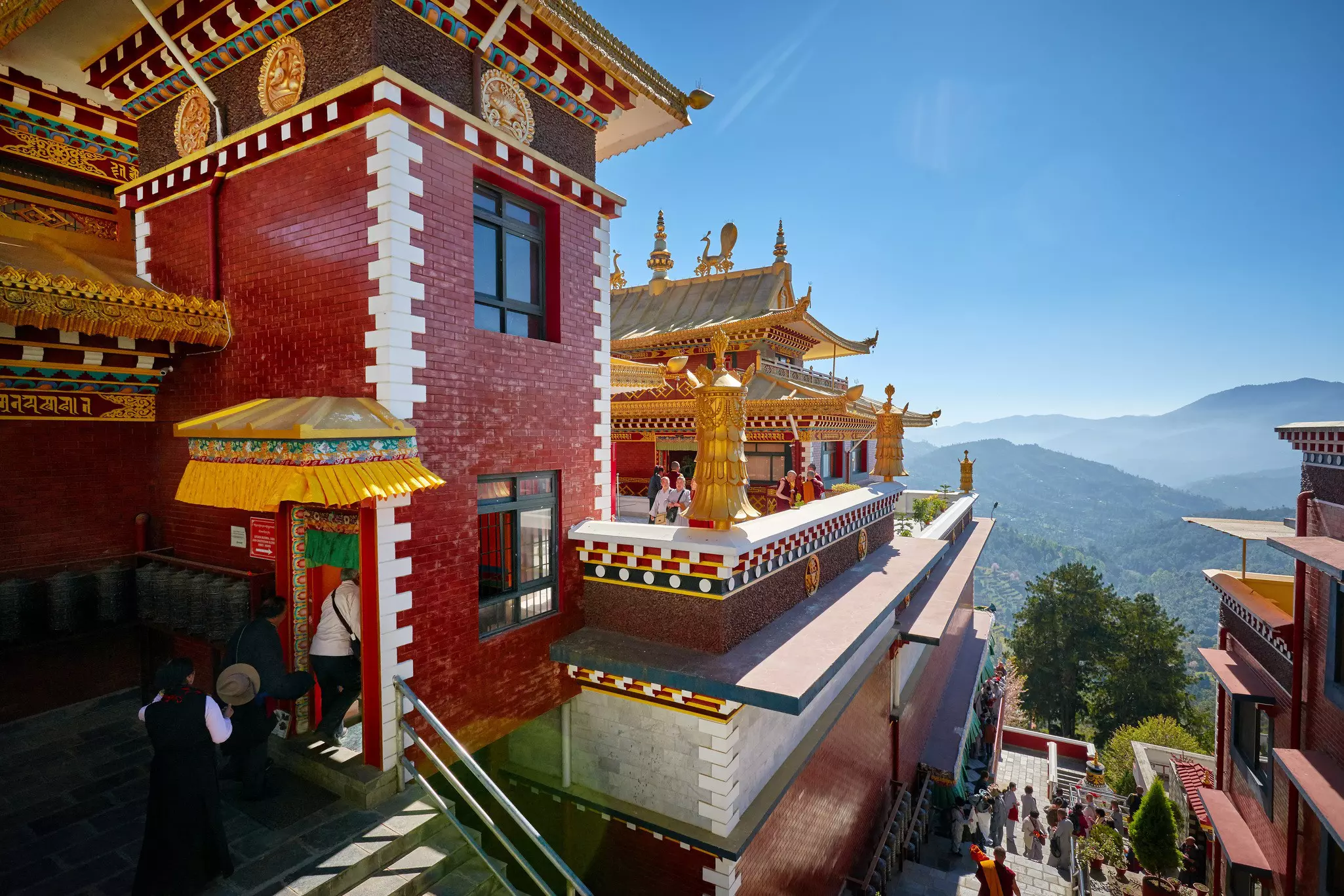 A red and gold monastery in the mountains