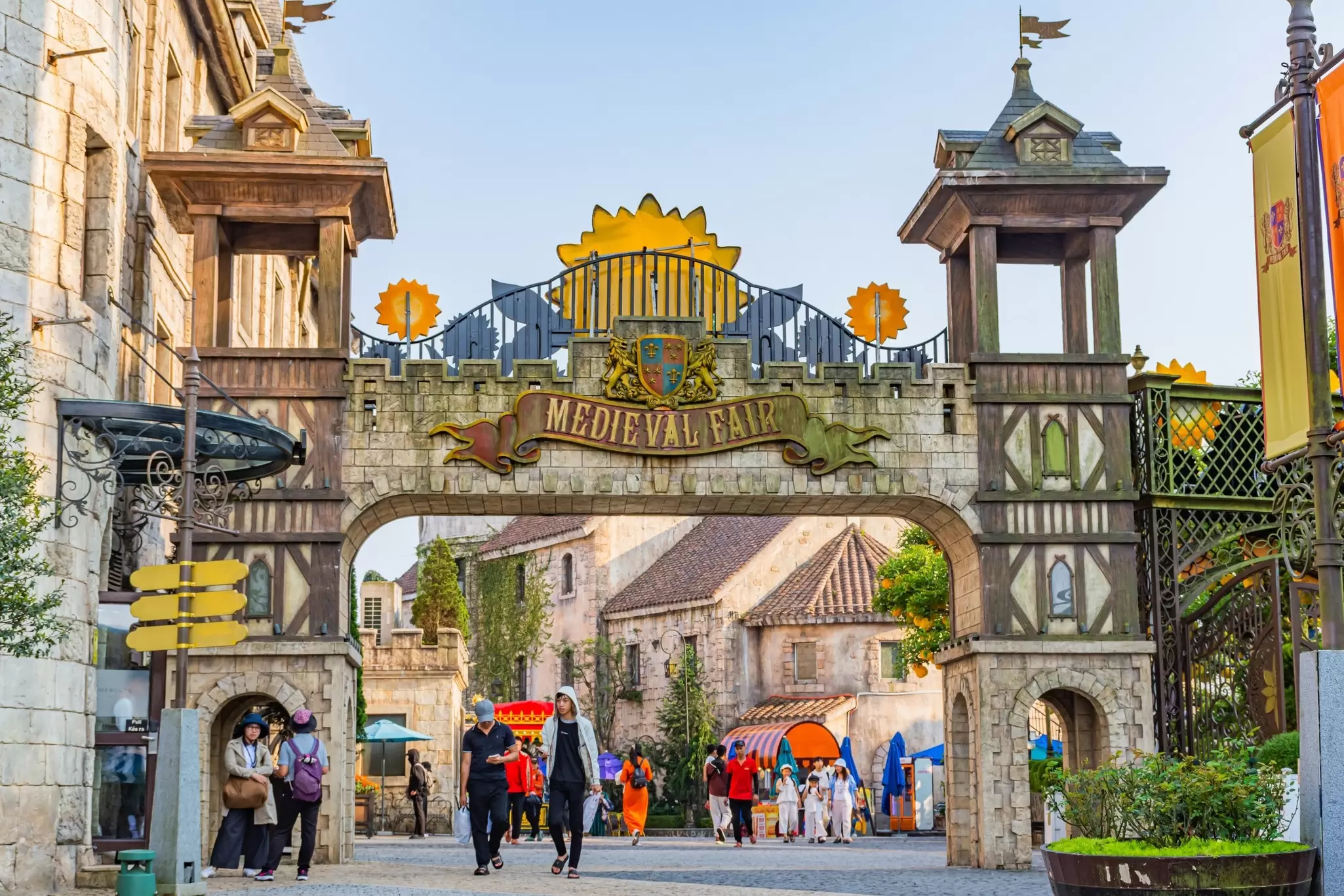 People walk past buildings built in the style of the European Middle Ages at a theme park in Danang, Vietnam