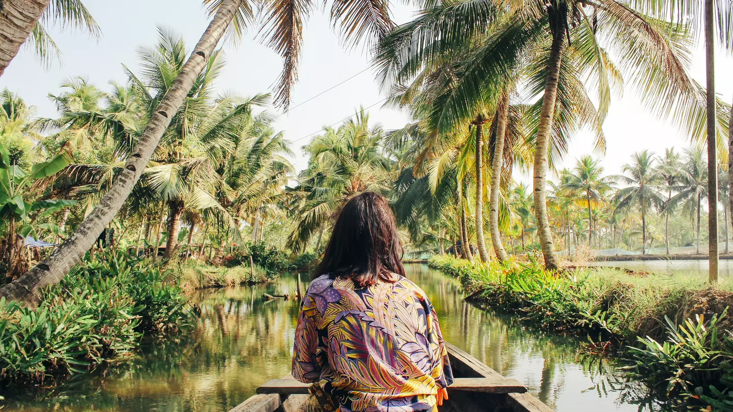A young woman kayaks through the backwaters of Monroe Island