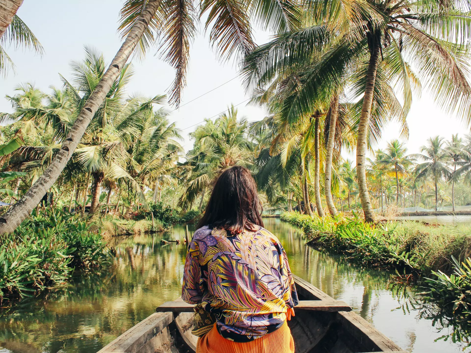 A young woman kayaks through the backwaters of Monroe Island