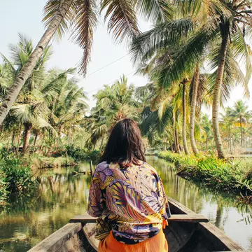 A young woman kayaks through the backwaters of Monroe Island