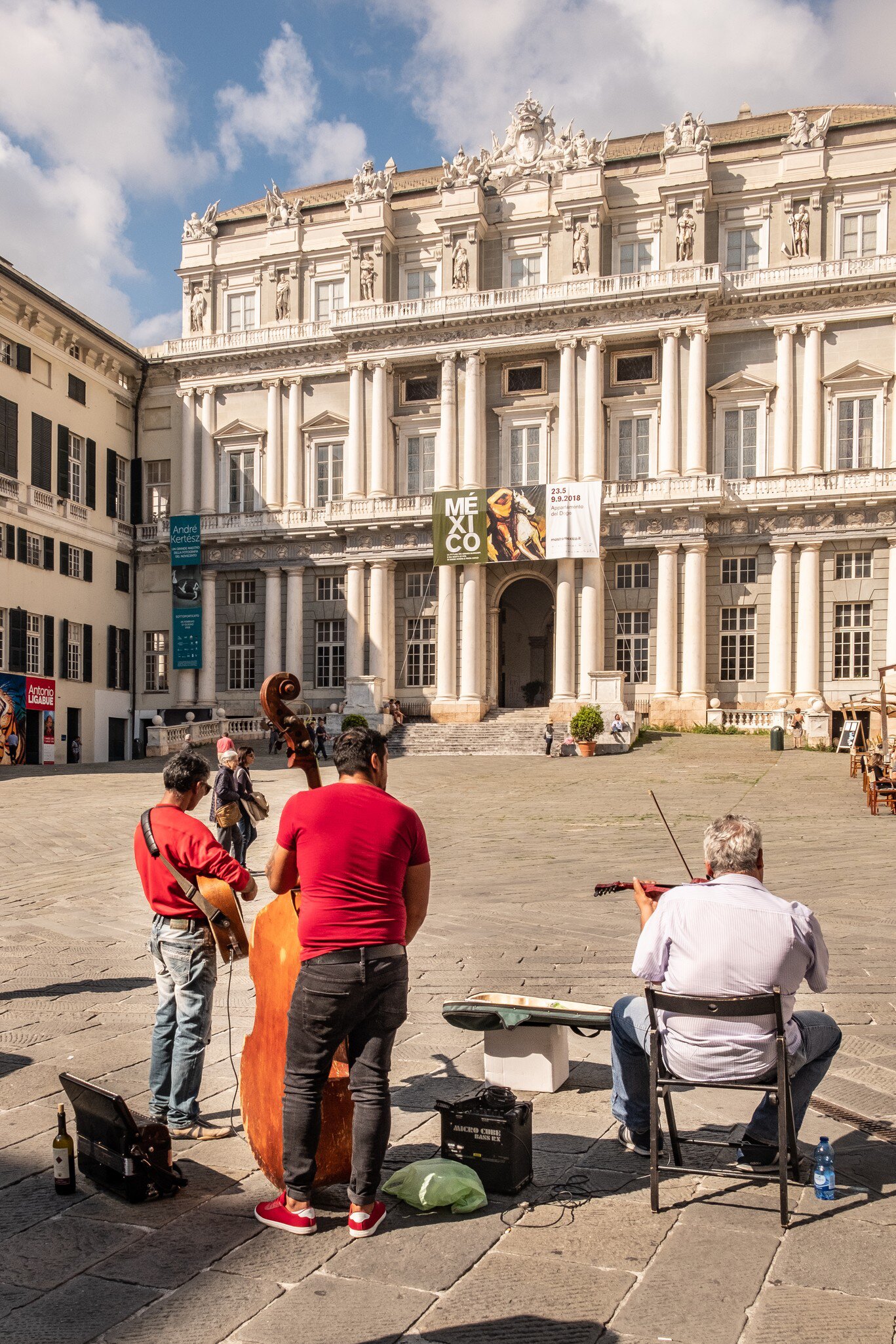 Piazza Matteotti with the historical palace Palazzo Ducale in the background, as a Romanian musicians group plays.