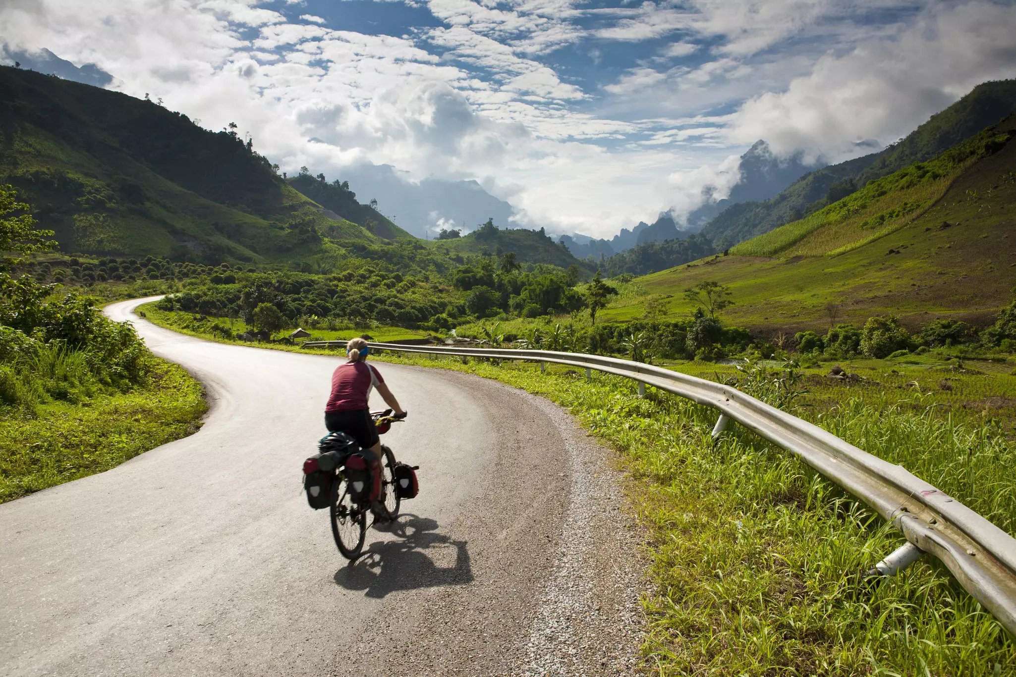 Cycling the Laos countryside. Mark Watson / Highlux / Getty Images