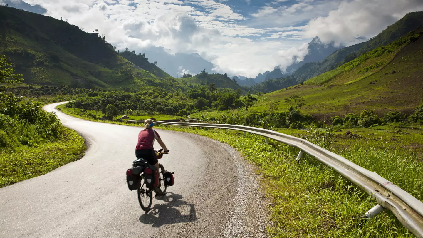 Cyclist riding on a road in Laos