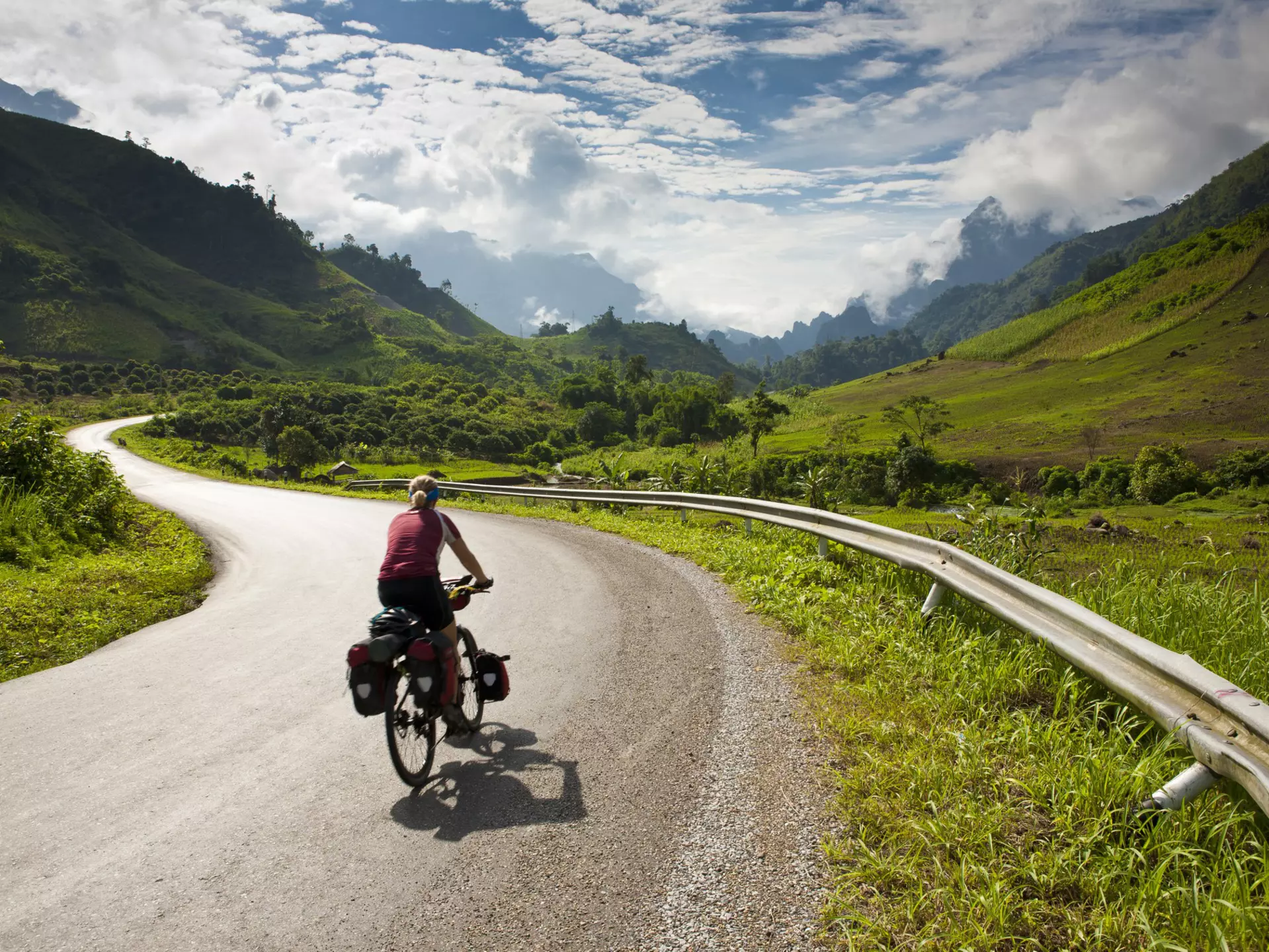 Cyclist riding on a road in Laos