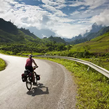 Cyclist riding on a road in Laos