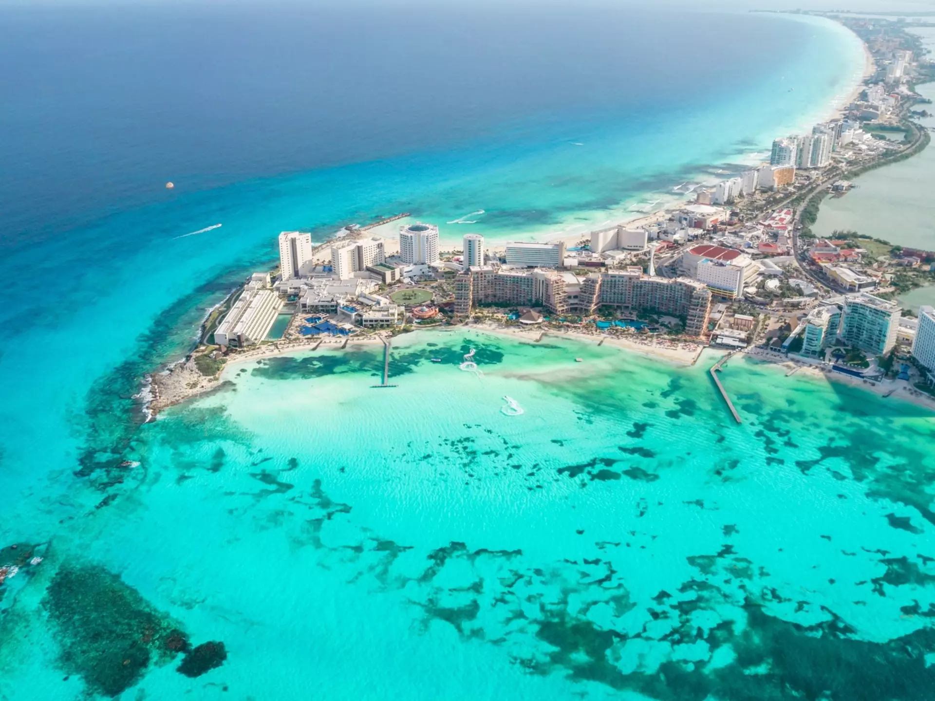 Panoramic aerial view of Cancun beach and city hotel zone in Mexico. Caribbean coast landscape of Mexican resort with beach Playa Caracol and Kukulcan road. 