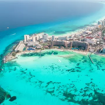 Panoramic aerial view of Cancun beach and city hotel zone in Mexico. Caribbean coast landscape of Mexican resort with beach Playa Caracol and Kukulcan road. 