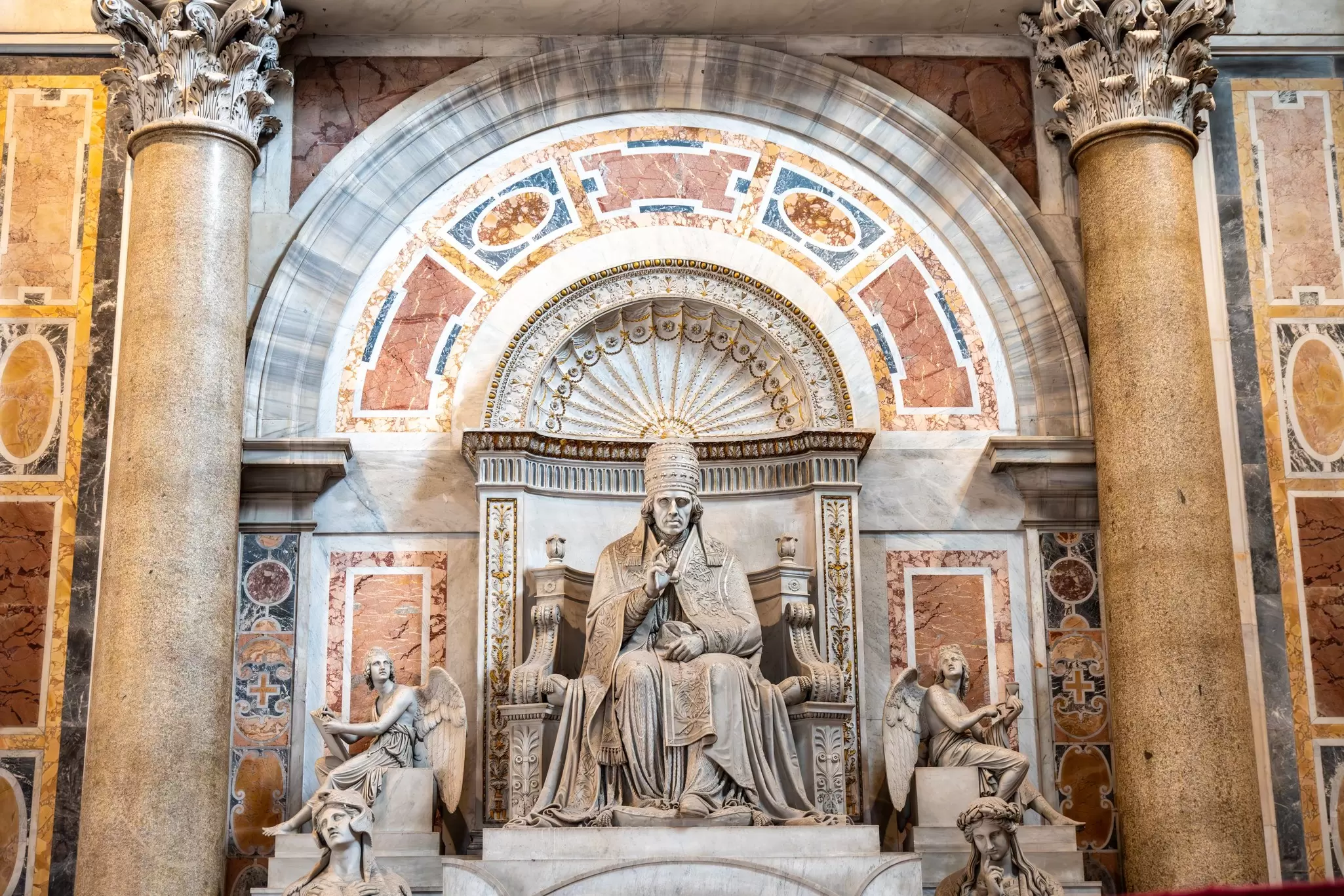 Sculpture of Pope Pius VII enthroned among angels in St. Peter's Basilica in the Vatican City in Rome, Italy.