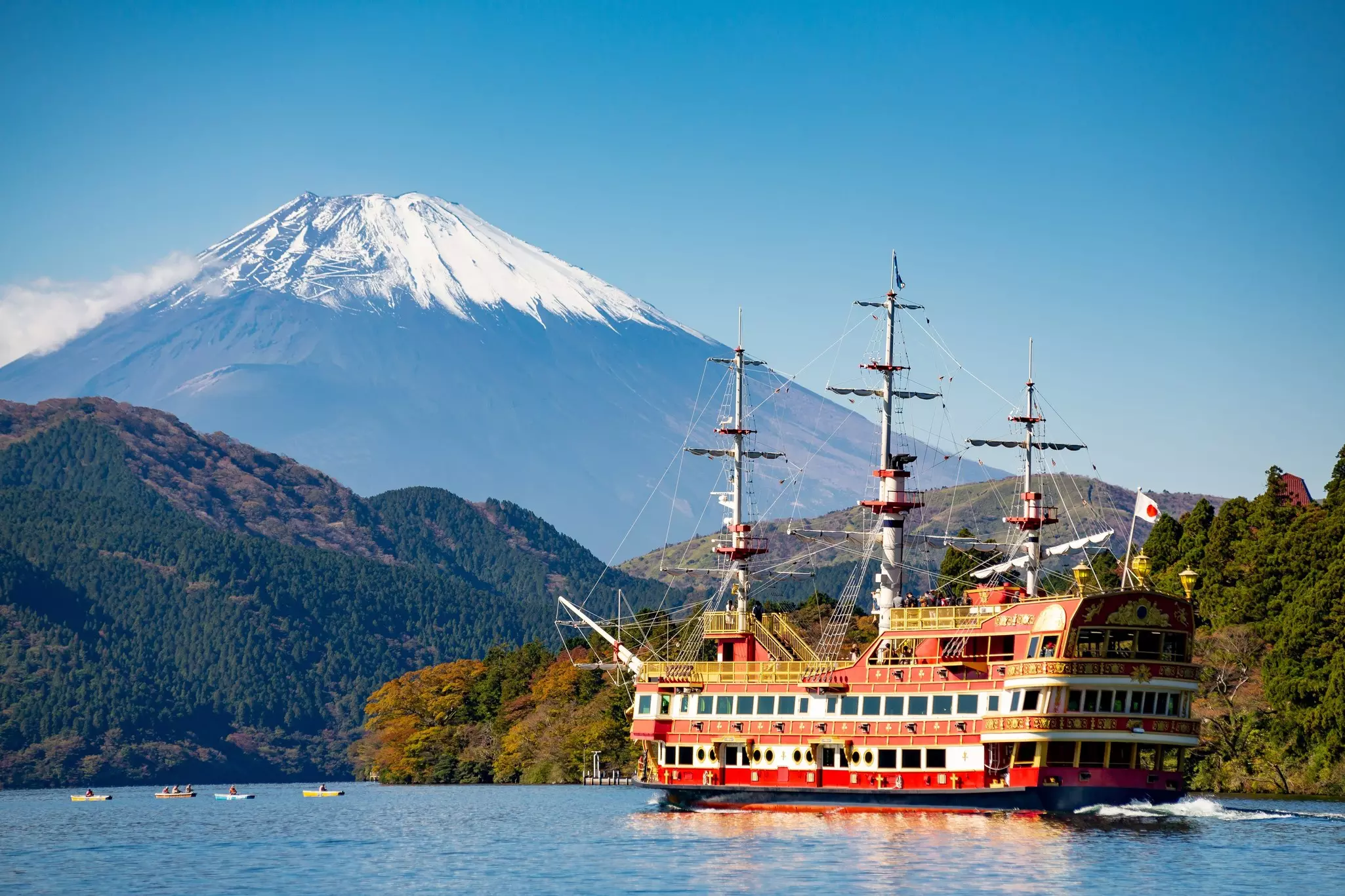 Mount Fuji, rising above a sightseeing boat on Ashi-no-ko lake in Hakone, Japan.