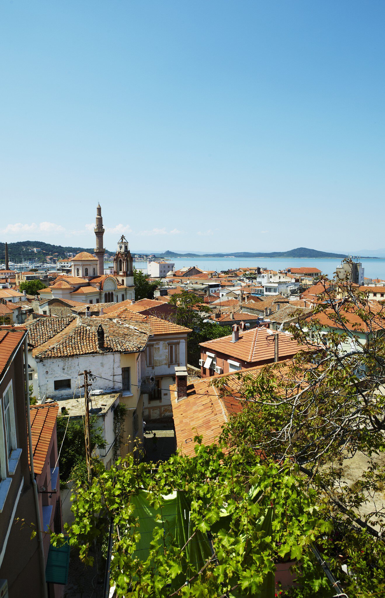 Terracotta rooftops of houses on Agean coast seen from Taksiyarhis Pension.