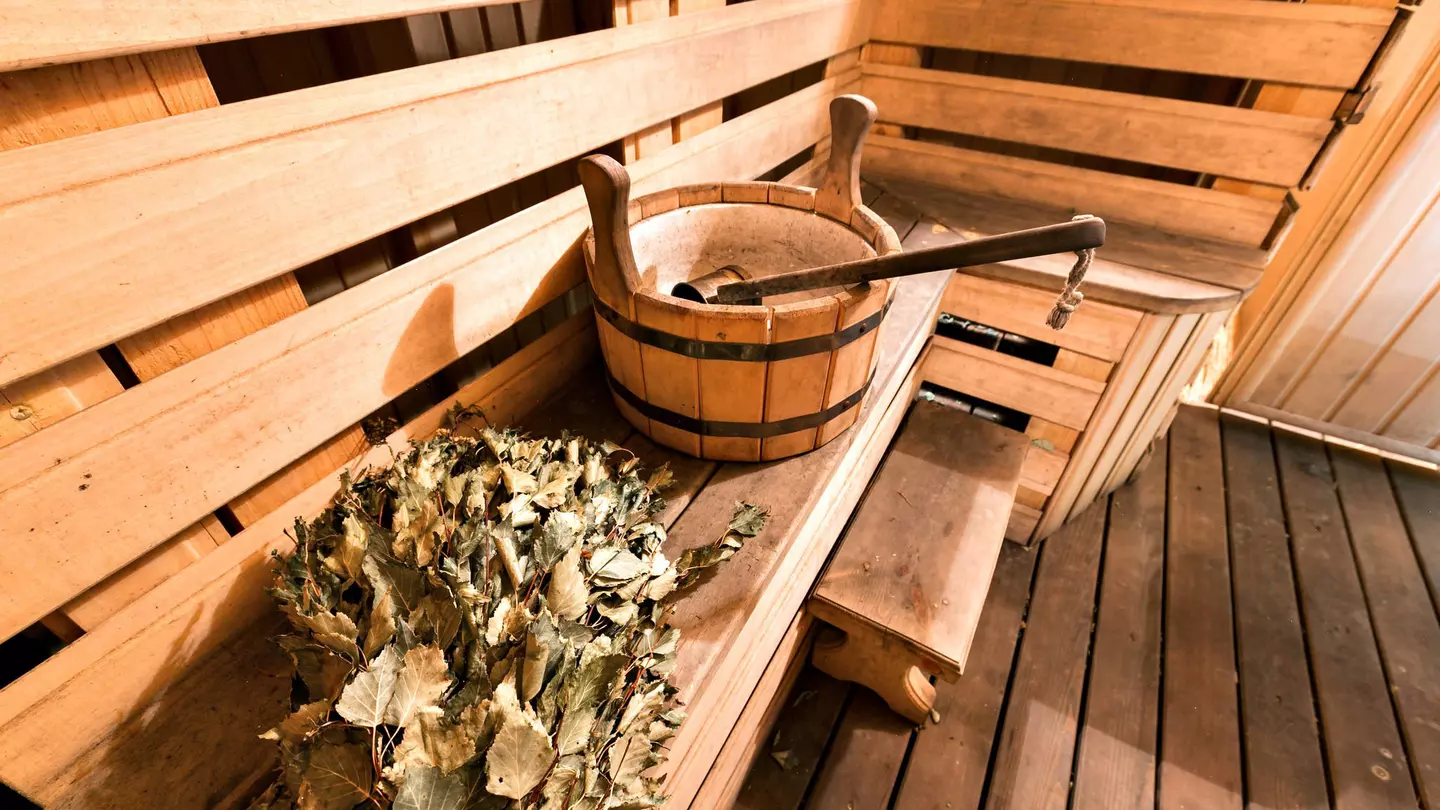 Empty wooden sauna room with ladle, bucket ready to be used