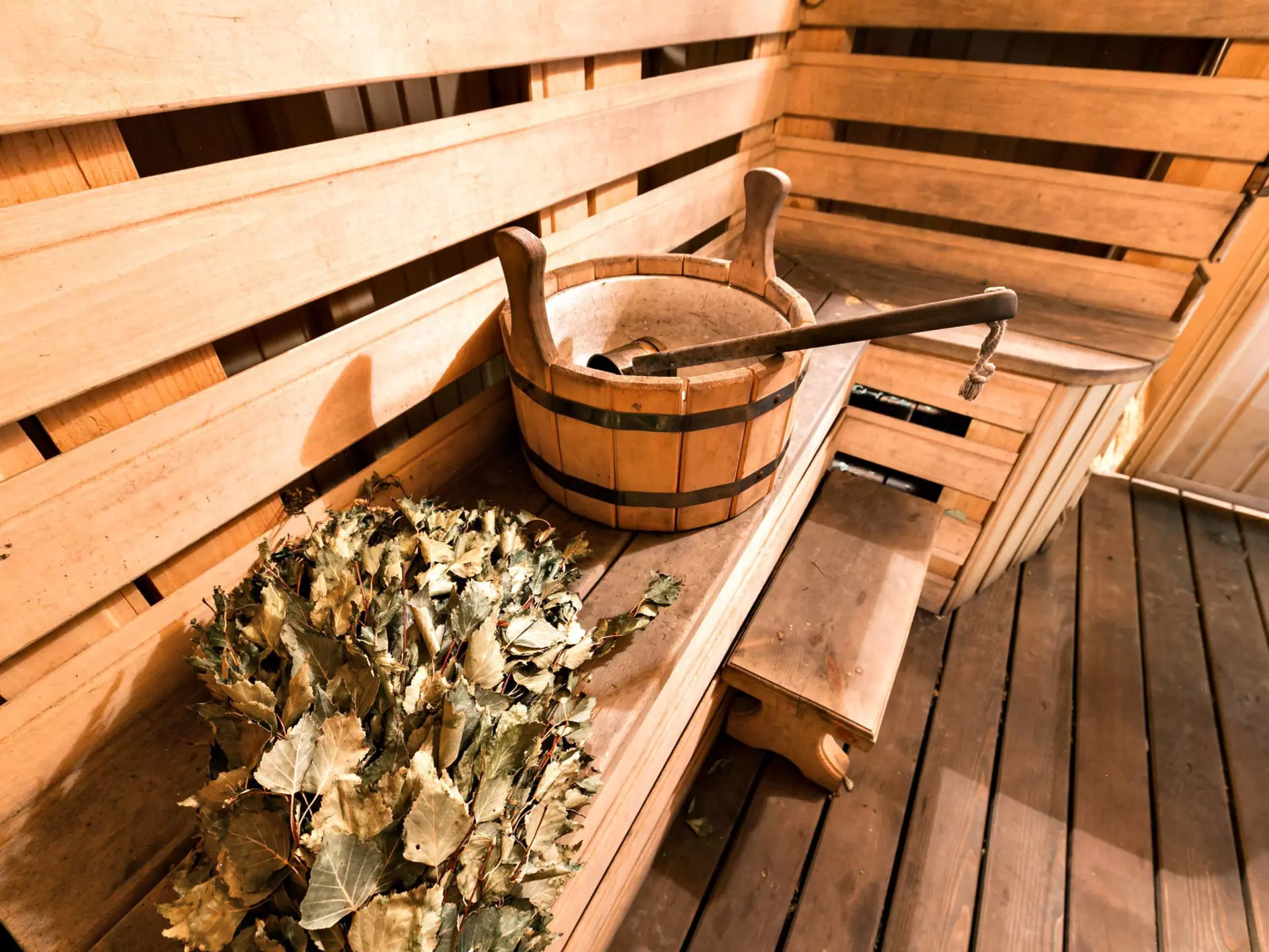 Empty wooden sauna room with ladle, bucket ready to be used