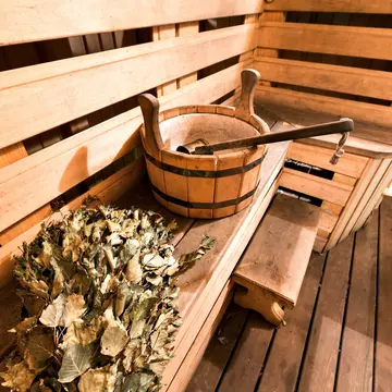 Empty wooden sauna room with ladle, bucket ready to be used