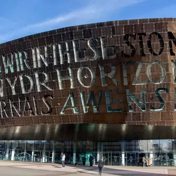 Wales Millennium Centre, Cardiff: bronze facade with window-letters reading IN THESE STONES HORIZONS SING, plus Welsh