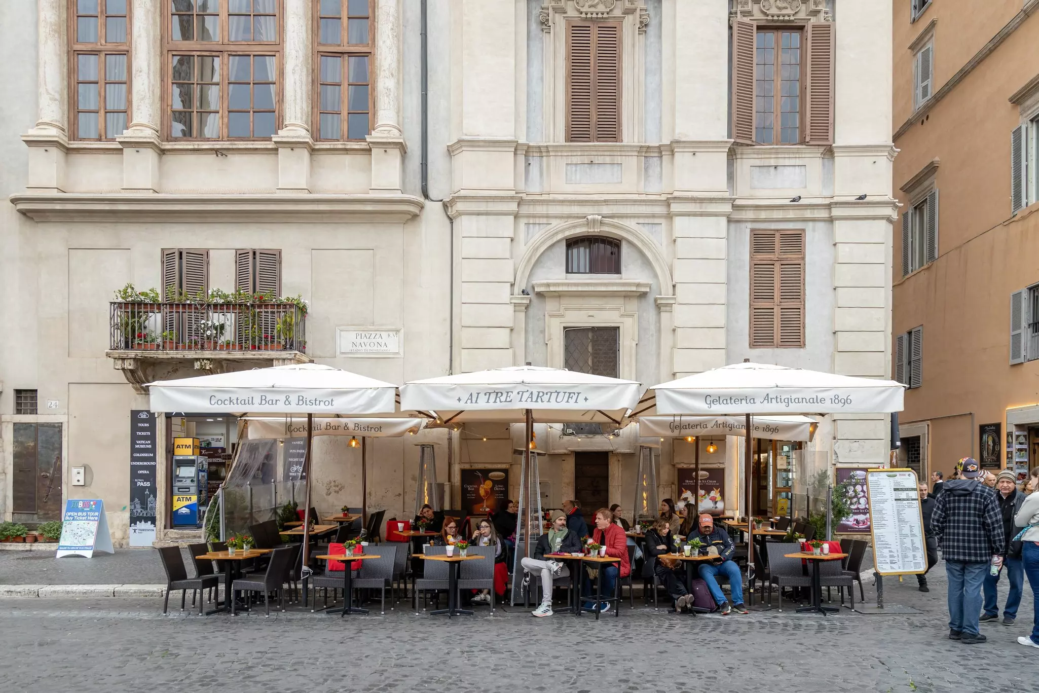 People enjoying outdoor seating at a restaurant and bar