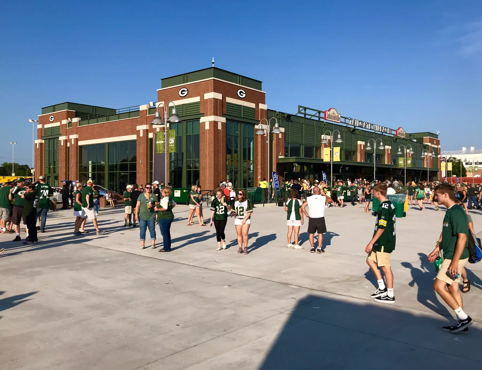 People walk outside of Lambeau Field on game day.