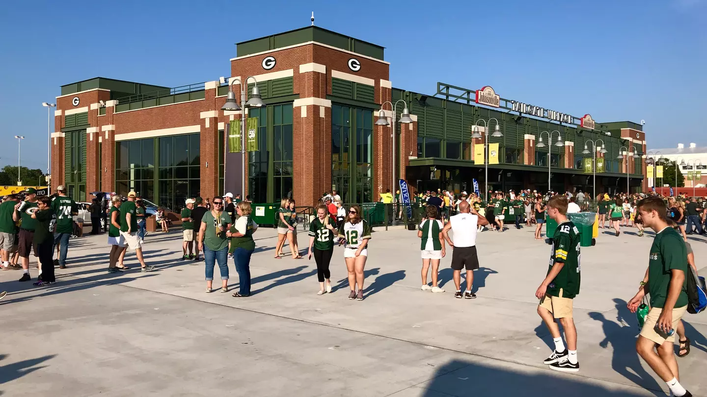 People walk outside of Lambeau Field on game day.