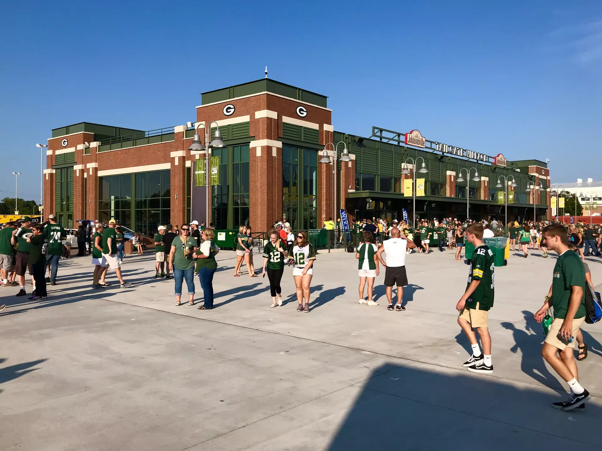 People walk outside of Lambeau Field on game day.