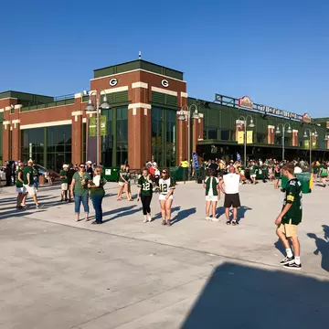People walk outside of Lambeau Field on game day.