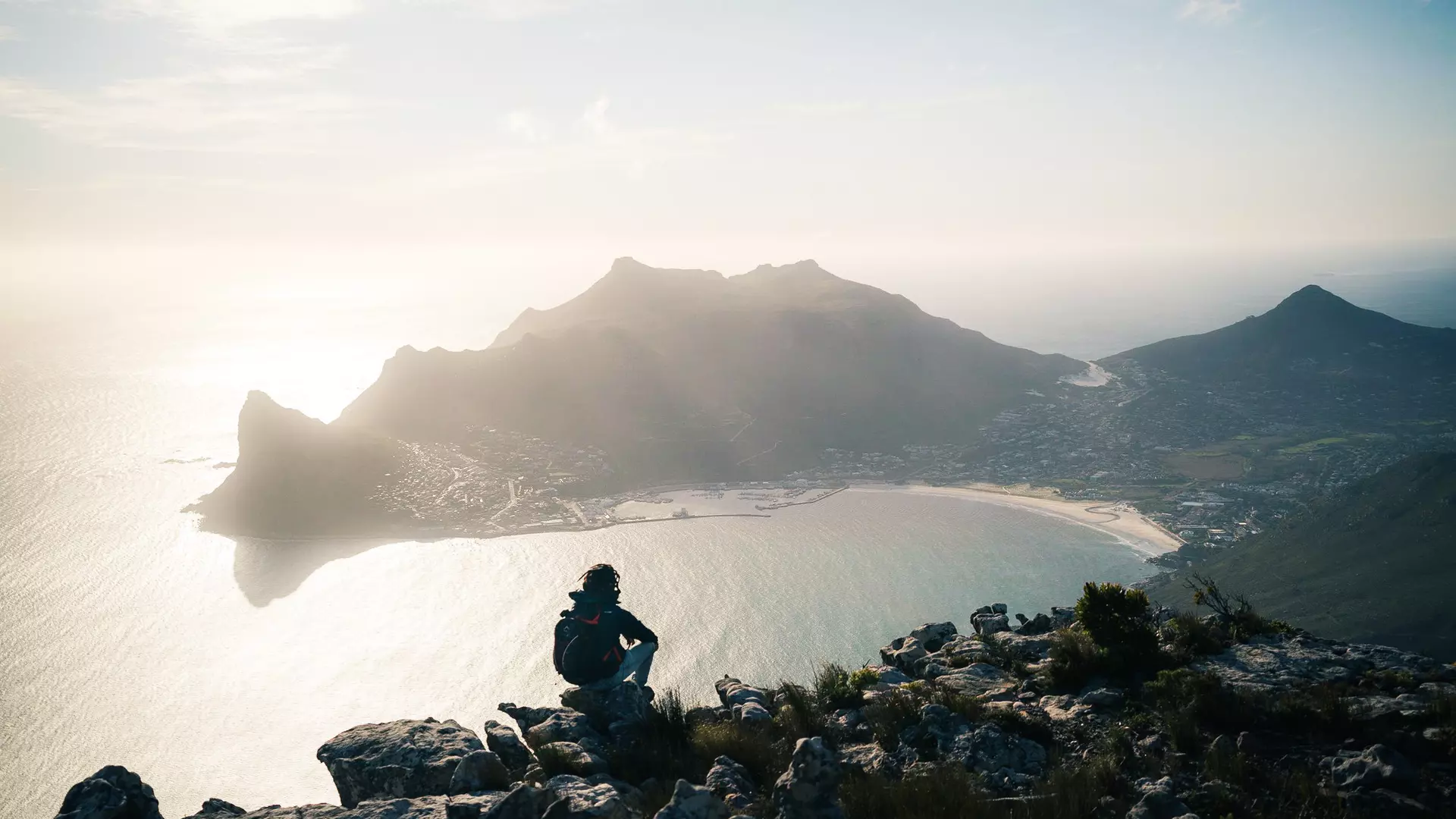 The hiking view from Silvermine Dam overlooking Hout Bay and Sentinel Peak in Cape Town, South Africa.