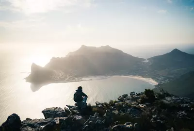 The hiking view from Silvermine Dam overlooking Hout Bay and Sentinel Peak in Cape Town, South Africa.
