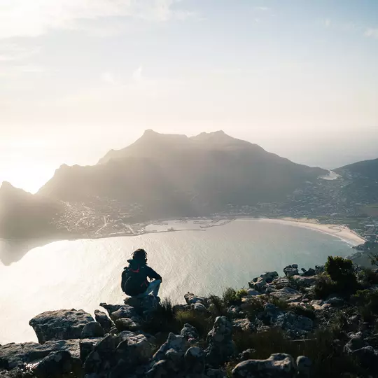 The hiking view from Silvermine Dam overlooking Hout Bay and Sentinel Peak in Cape Town, South Africa.