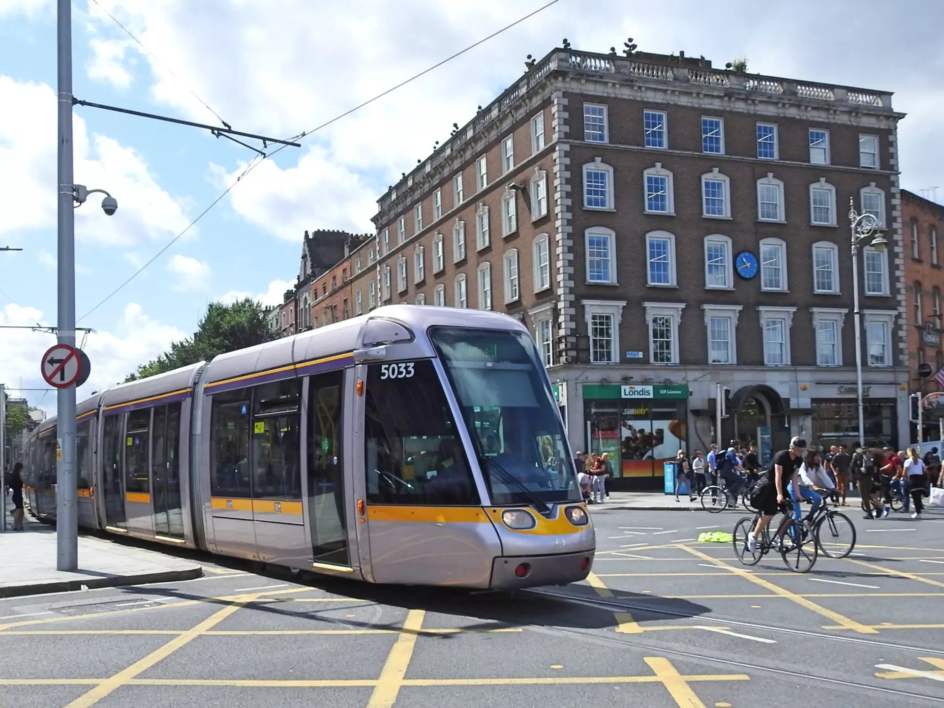 A light rail Luas tram train heading toward O'Connell Bridge in Dublin City Centre.