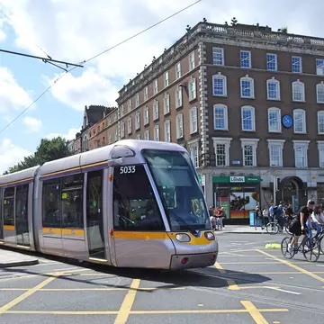 A light rail Luas tram train heading toward O'Connell Bridge in Dublin City Centre.
