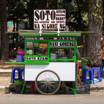 Jakarta, Indonesia - October 20, 2019: Street food stall, in which sell nasi goreng, mie ayam, bakso... Typical Indonesian food, in the Central Jakarta district. Travel photography., License Type: media, Download Time: 2025-06-05T18:17:59.000Z, User: LP_ASouza, Editorial: true, purchase_order: 65050 - Digital Destinations and Articles, job: Lonely Planet, client: How to travel to Indonesia on a budget, other: Amy Souza