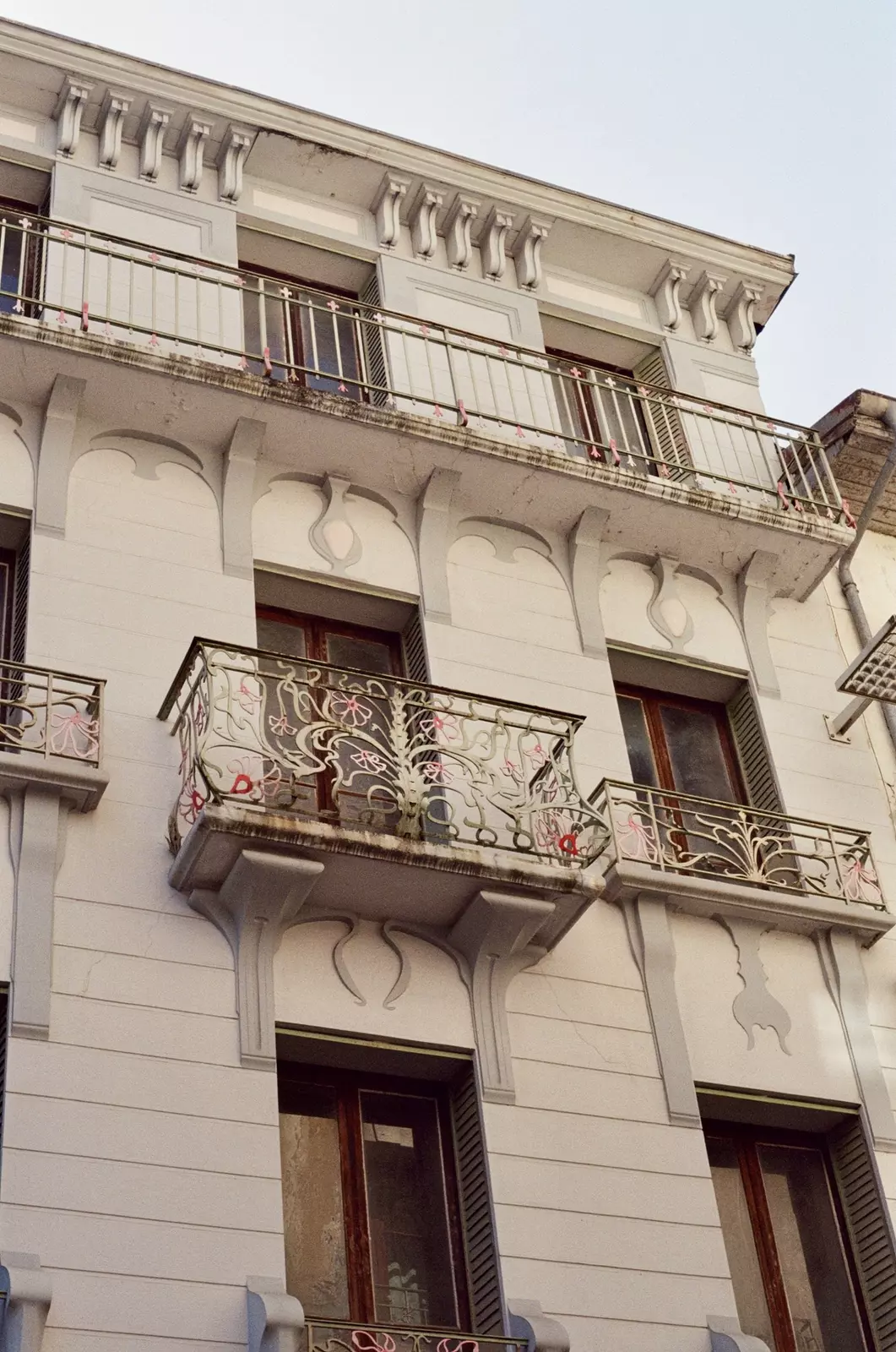 The balcony and shuttered windows on a Belle Époque building
