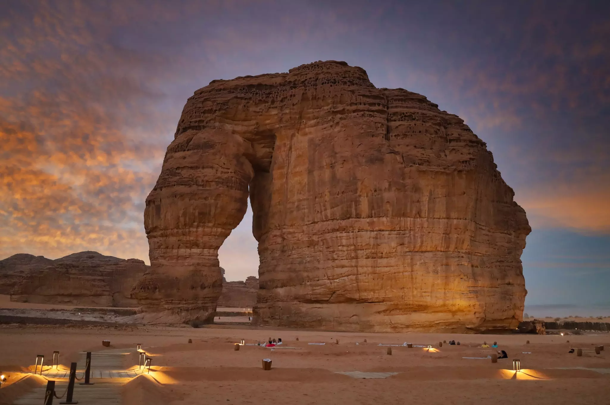A sandstone rock resembling an elephant in profile at sunset.