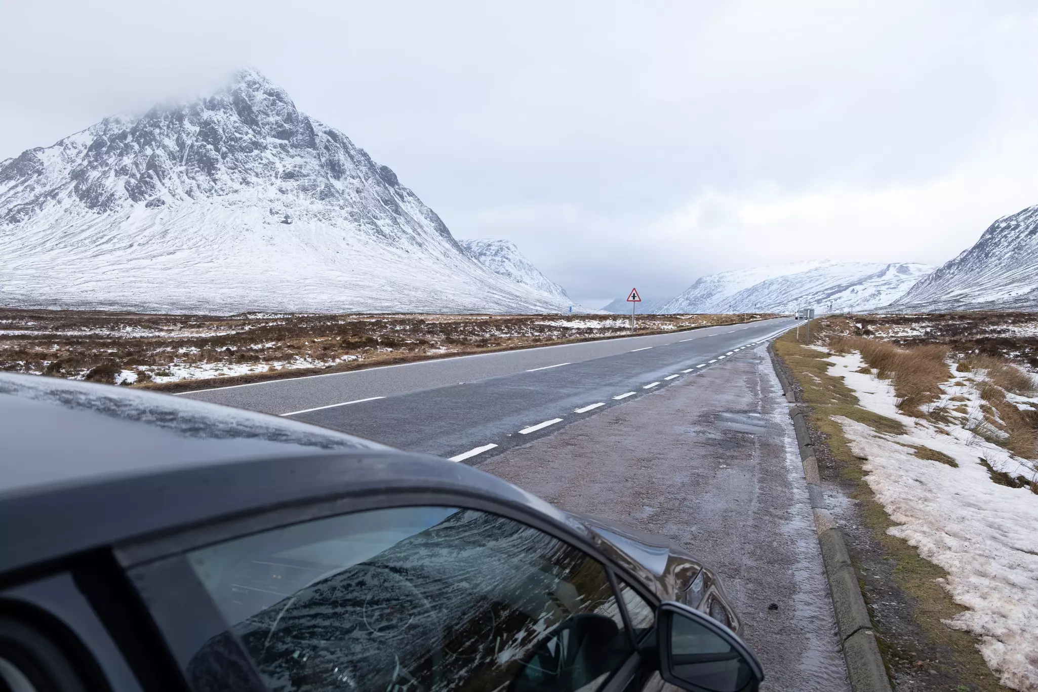 A snowy road in Glencoe in the Scottish Highlands, Scotland.