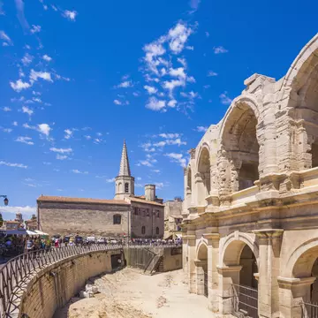 The remains of a Roman amphitheater in a city center. 