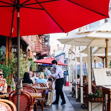A server wearing a protective mask helps customers sitting in the outdoor dining section of a restaurant in the Little Italy neighborhood of New York, U.S., on Wednesday, May 19, 2021. New York lifted its mask mandate on Wednesday for fully vaccinated people as Covid vaccinations approach 50% of the state's residents and cases and hospitalizations ebb. Photographer: Nina Westervelt/Bloomberg via Getty Images
1233002482
u.s.a., covid 19, heat, warm weather, covid19, us, viral, americas, communicable diseases, coronavirus2021, pandemic, infectious diseases, disease, illness, health, united states of america, american, nyc manhattan, north american