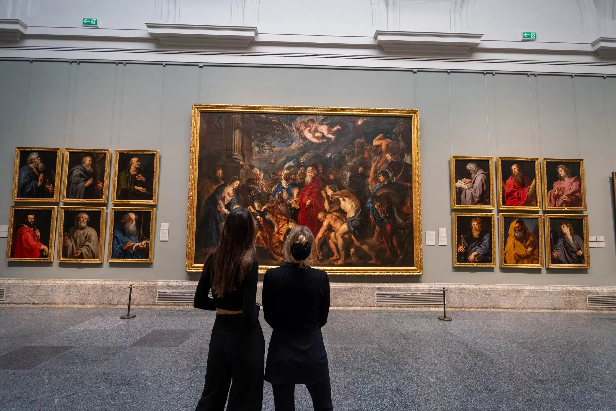 Two women looking at paintings on display at the Prado in Madrid, Spain.