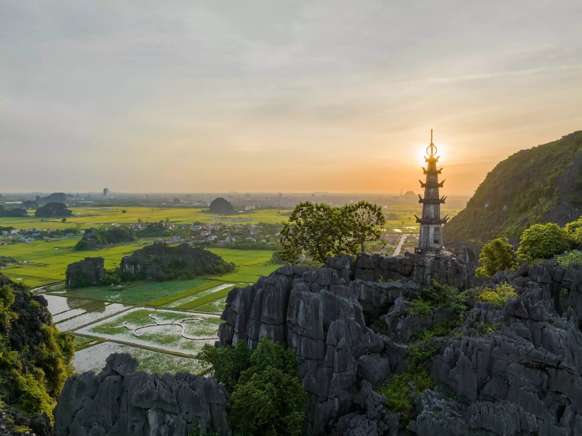 View of the Mua Cave mountain viewpoint as the sun sets over Tam Coc, Ninh Binh, Vietnam.