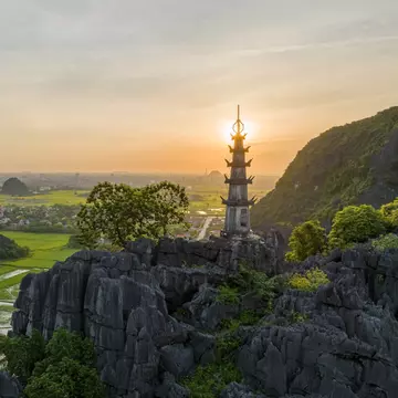 View of the Mua Cave mountain viewpoint as the sun sets over Tam Coc, Ninh Binh, Vietnam.