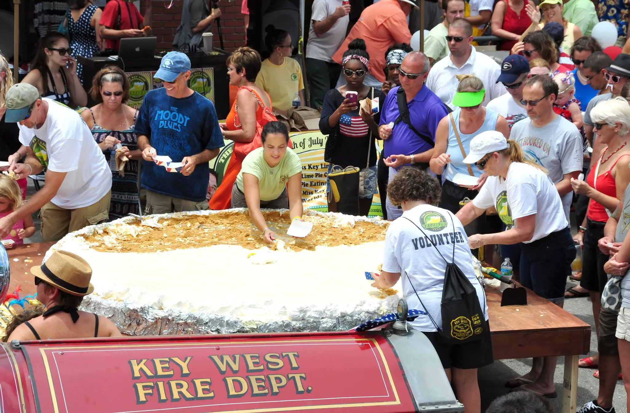 ieces of the largest Key Lime pie in the world are handed out to tourists and locals alike on July 4, 2013, in Key West, Florida, at the first annual Key Lime Pie Festival