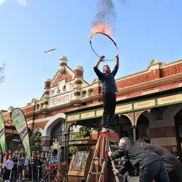 FREMANTLE, WA - JULY 18 2021:Crowed of people watching street acrobatics show at Fremantle Markets one of the most popular tourist attractions in Fremantle Western Australia., License Type: media, Download Time: 2026-04-23T18:24:22.000Z, User: LP_NZhan, Editorial: true, purchase_order: 65050 - Digital Destinations and Articles, job: App content, client: Lonely Planet App, other: Nadine Zhan