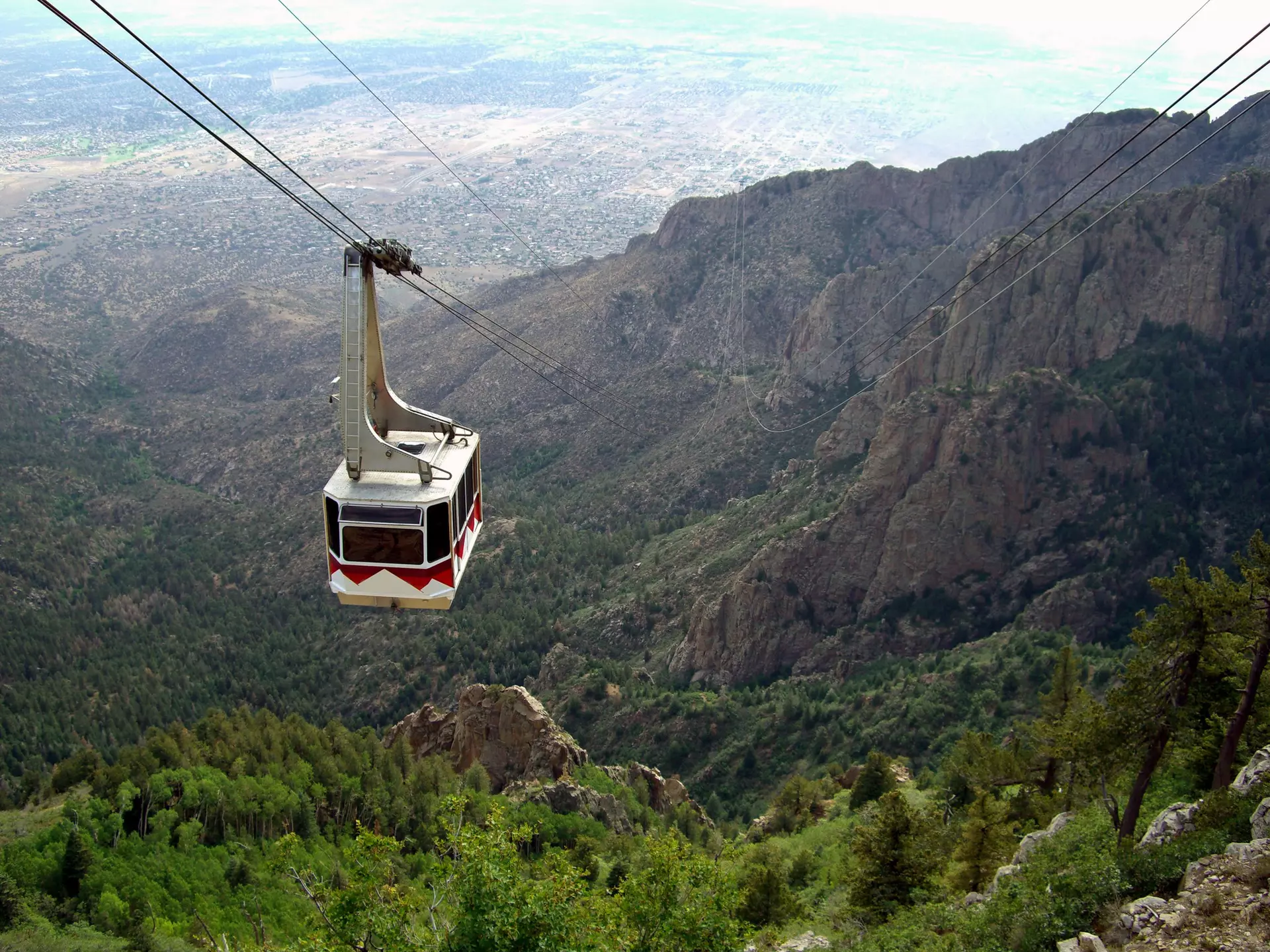 A cable car at the Sandia Peak Tramway approaching the top of Sandia Mountain, with the city of Albuquerque in the background.
139979801
Mexico, Tramway, Scenics - Nature, Mountain, Car, Tree, Landscape - Scenery, Forest, Cable Car, Albuquerque - New Mexico, City, Travel, Landscape, Steel Cable, New, Horizontal, New Mexico, No People, Outdoors, Photography, Sandia Peak