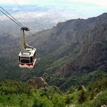 A cable car at the Sandia Peak Tramway approaching the top of Sandia Mountain, with the city of Albuquerque in the background.
139979801
Mexico, Tramway, Scenics - Nature, Mountain, Car, Tree, Landscape - Scenery, Forest, Cable Car, Albuquerque - New Mexico, City, Travel, Landscape, Steel Cable, New, Horizontal, New Mexico, No People, Outdoors, Photography, Sandia Peak