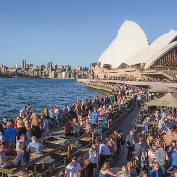 A busy Sydney Harbour leading up to the Opera House as both locals and tourists alike enjoy some drinks and socialising at Opera Bar.