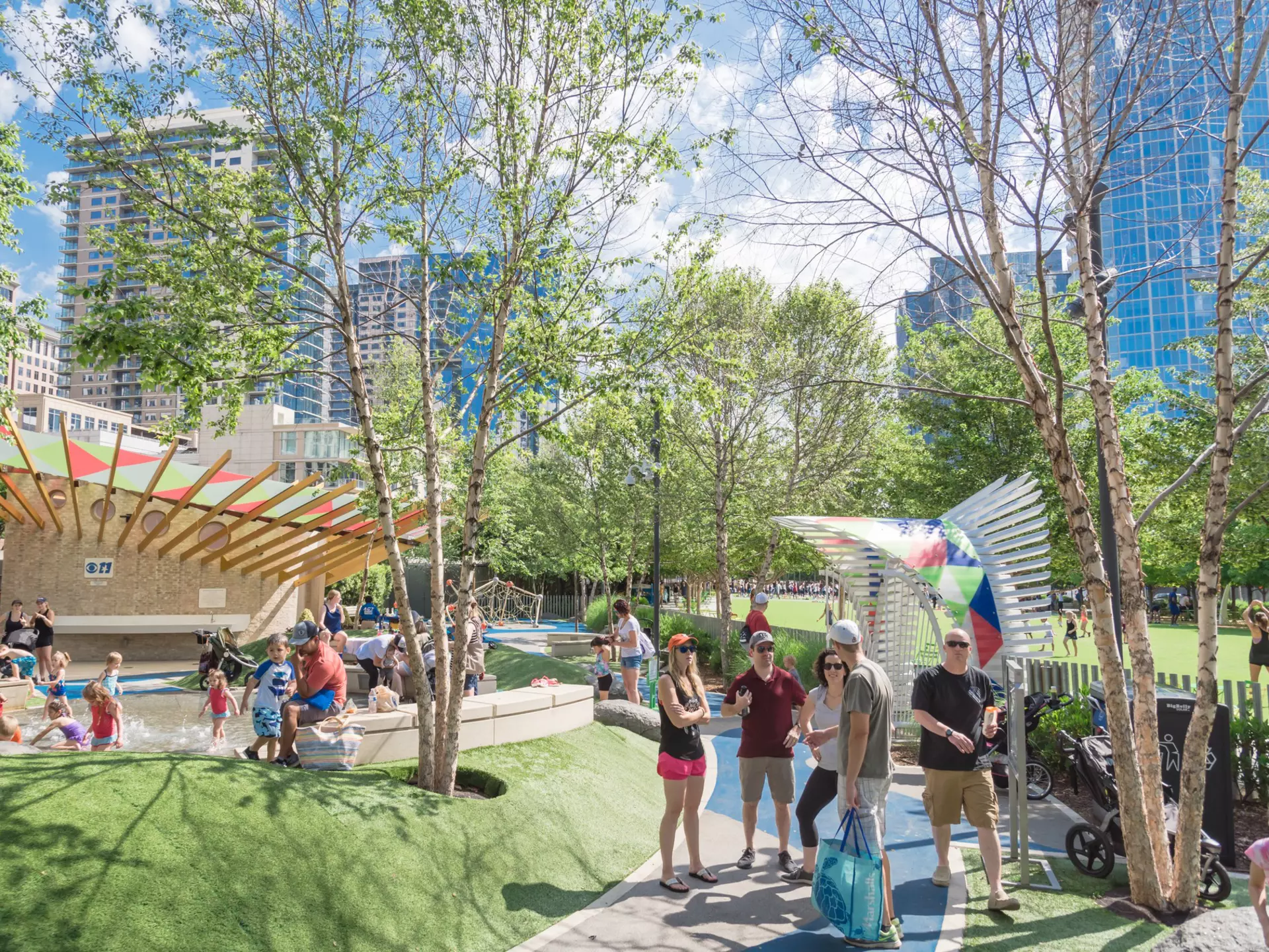 DALLAS, TX, USA-MAY 26, 2018:Water fountain, splash pad at children area in Klyde Warren Park. 5.2-acre public place in downtown Dallas. Surrounded by artificial turf berms, concrete seating, boulders  License Type: media  Download Time: 2021-06-10T19:48:51.000Z  User:   Is Editorial: Yes  purchase_order:   