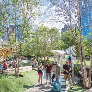 DALLAS, TX, USA-MAY 26, 2018:Water fountain, splash pad at children area in Klyde Warren Park. 5.2-acre public place in downtown Dallas. Surrounded by artificial turf berms, concrete seating, boulders  License Type: media  Download Time: 2021-06-10T19:48:51.000Z  User:   Is Editorial: Yes  purchase_order:   
