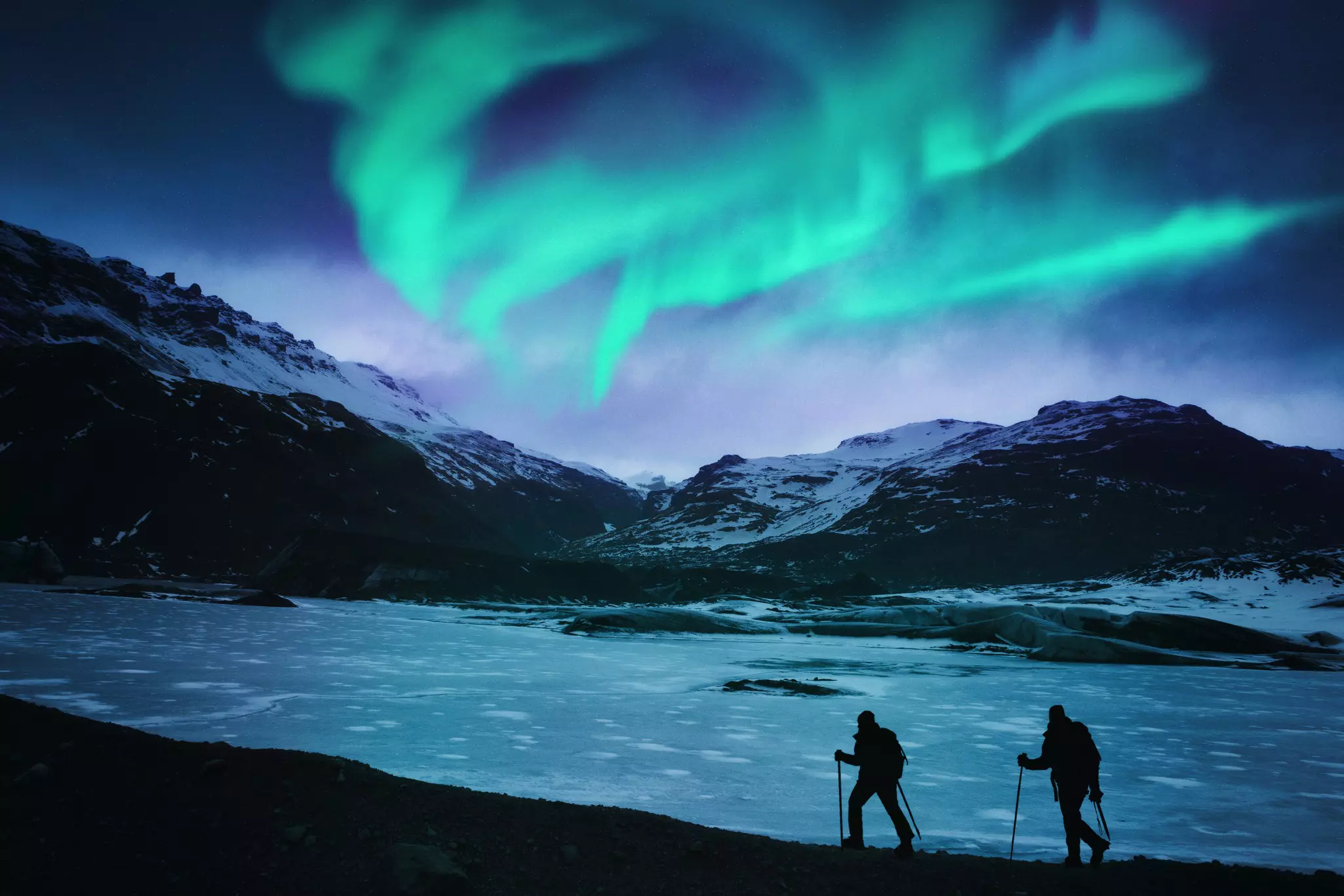 Hikers under the northern lights in Iceland