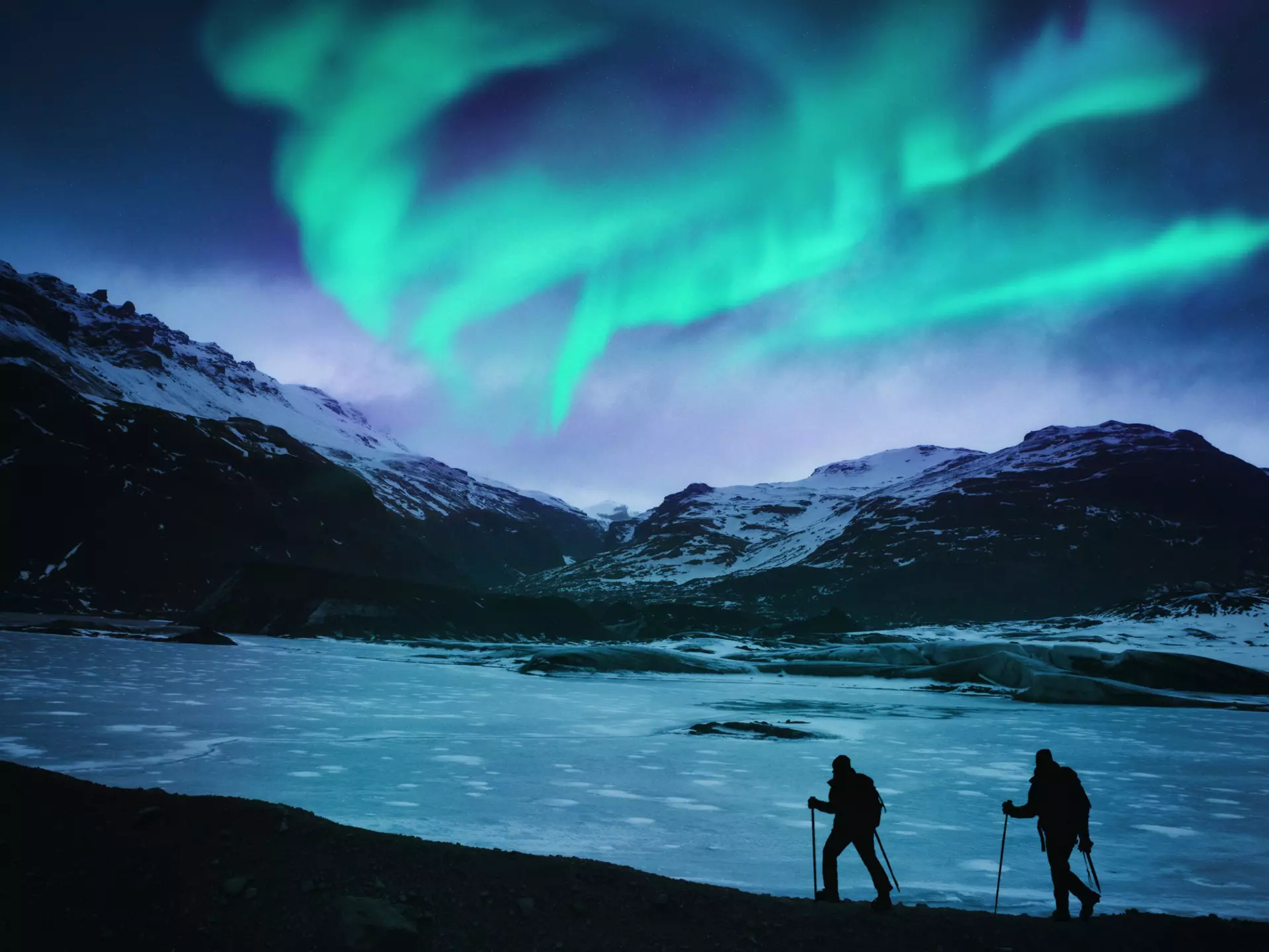 Hikers under the northern lights in Iceland