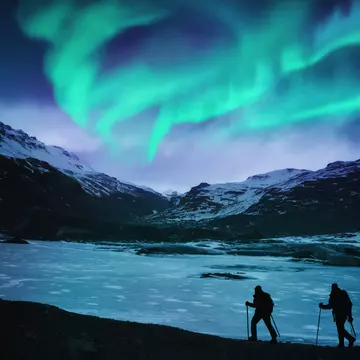 Hikers under the northern lights in Iceland